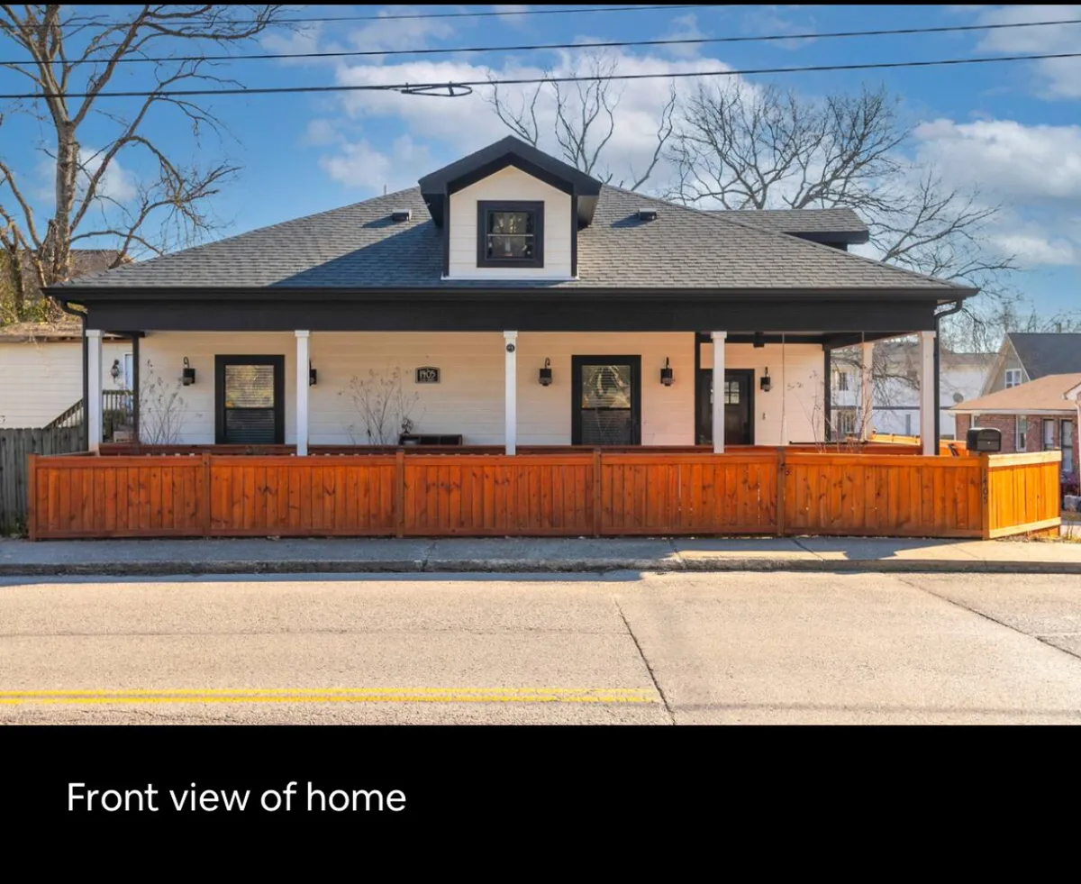 This image showcases the welcoming front porch of the home, framed by a wooden fence and classic roofline, with inviting windows that create a friendly curb appeal. The porch looks like an ideal spot to relax and enjoy the neighborhood vibe, reinforcing the home's connection to the surrounding Germantown area.